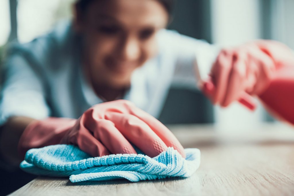 A female nurse cleaning at a house