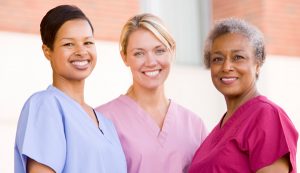 Three female nurses and carers smiling