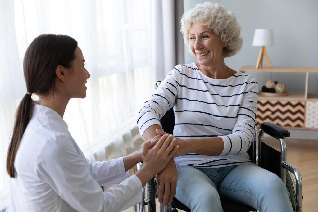 aged care gold coast elderly woman in a wheelchair talks to a young woman